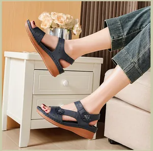 Comfortable navy blue wedge sandals featuring floral appliques and platform soles in a home setting