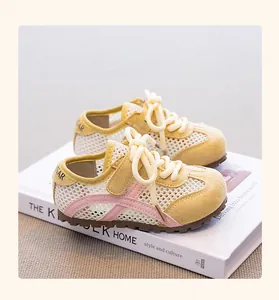Breathable yellow mesh girls sneakers on a minimalist white book prop