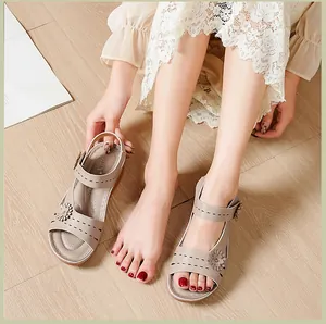 Detailed view of women's comfortable platform sandals with floral accent on feet.