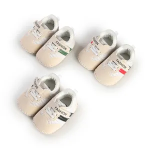 Detail view of three pairs of striped breathable baby walking shoes with soft soles