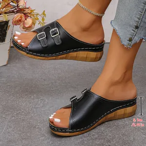 Side detail view of black peep toe wedge sandals featuring a 5.1cm platform heel.