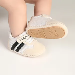 Detail showing breathable striped baby walker shoes with a soft, non-slip sole.