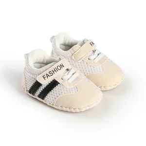 Detailed close-up of beige striped breathable baby walking shoes with mesh fabric