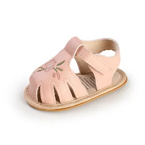 Detailed side view of pink embroidered soft sole leather sandals for infant girls