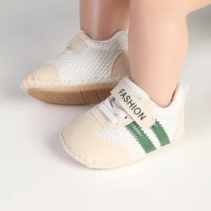 Close-up of breathable mesh baby walking shoes with green stripes and soft sole