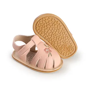 Detail view of pink baby walking sandals with embroidered flower and soft anti-slip sole