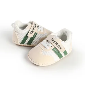Detailed view of breathable beige baby pre-walker shoes with green stripes and mesh