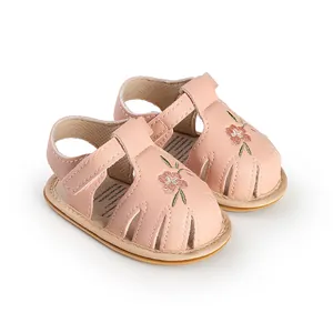 Close-up of pink floral embroidered baby walker sandals with soft flexible soles