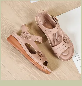Close-up of pink comfort wedge sandals with floral accents and hook-and-loop closure