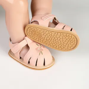 Detailed view of pink baby sandals with floral embroidery and soft non-slip sole