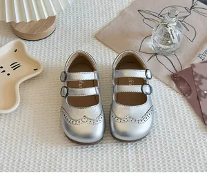 Elegant silver girls' Mary Jane shoes with double buckle straps and brogue details