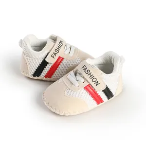 Close-up of breathable baby walking shoes with red and black stripes and Velcro strap