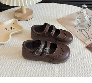 Vintage brown girls' leather Mary Jane shoes with brogue wingtip and double buckles