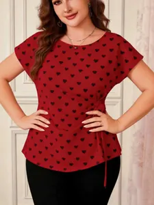 Detailed view of plus size red short sleeve blouse with black heart print and waist tie detail