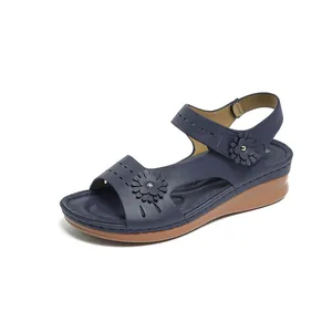 Navy blue platform wedge sandals for women with floral cutout details and Velcro strap.