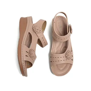 Elegant women's dusty pink wedge sandals with decorative flower accents and comfort sole