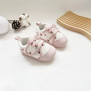 Detailed view of baby girl soft-sole walking shoes with cute strawberry pattern and bow