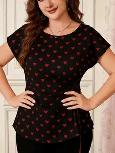 Close-up detail of women's plus size black top with red heart print and side waist tie