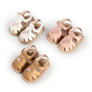 Detailed view of baby girl sandals in three colors with delicate flower embroidery.