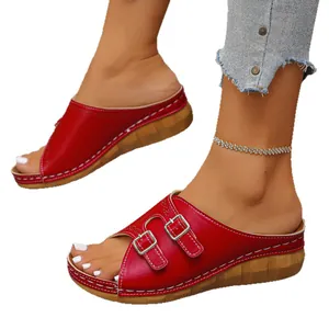 Red women's platform wedge sandals with adjustable buckle straps and peep toe design