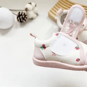 Detail view of pink strawberry print baby girl soft-sole walking shoes with velcro