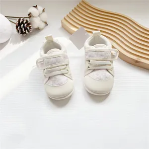 Detailed view of floral pattern and velcro strap on soft-soled baby walking shoes