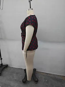Side view of plus size black short sleeve top with red heart print and side tie