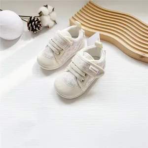 Detail of floral baby girl walking shoes with soft soles and velcro straps
