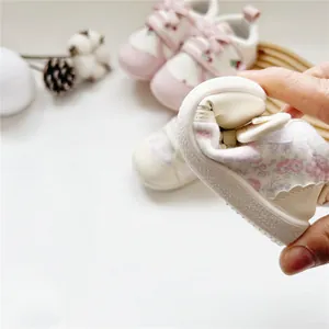 Close-up of flexible soft sole baby girl walking shoe with floral pattern