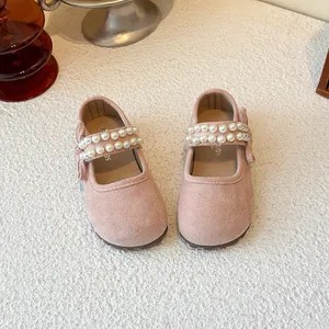 Elegant pink suede-like girls princess shoes featuring double pearl straps and sweet bow detail