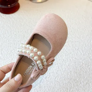 Charming pink suede baby girl princess shoes featuring elegant pearl strap and bow detail