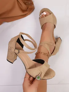 Detailed view of elegant beige suede chunky heel sandals with double ankle buckle straps