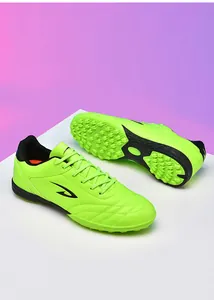 Vibrant fluorescent green TF turf soccer shoes showing sole and side profile for training