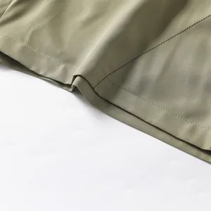 Detail of olive green quick-dry sports shorts showing high-quality stitching and fabric