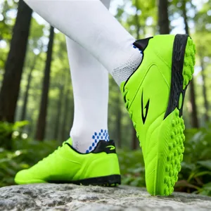 Vibrant neon green TF soccer shoes designed for breathable outdoor turf training and matches.