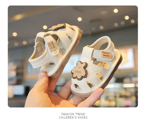 Detailed view of cream baby sandals with cute bear design and soft sole for toddlers