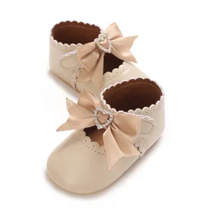 Detailansicht beige Baby-Prinzessinenschuhe mit Schleife und Herz-Strass