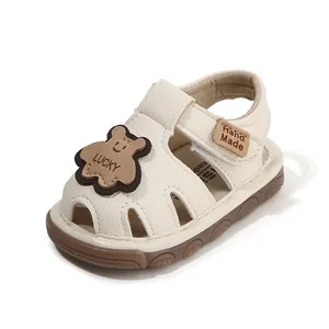 Off-white soft sole baby sandals with cute bear patch and non-slip rubber bottom