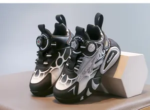Detail shot of black and white children's sports shoes with rotary buckle closure.