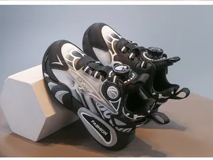 Detail view of black and white children's functional sneakers with rotary buckle system.