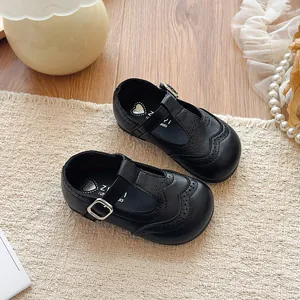 Classic black leather T-strap girls' shoes with elegant brogue wingtip detailing for performance