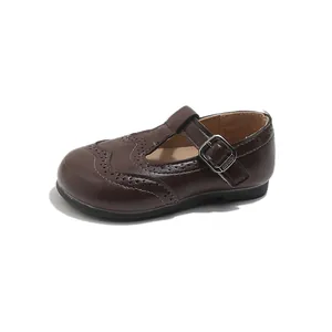 Classic dark brown leather T-strap shoes for girls featuring elegant brogue detailing