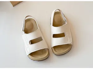 Dettaglio dei sandali da spiaggia bianchi per bambini con pratico velcro regolabile