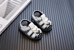 Detailed macro view of baby cartoon bear sandals with white soft soles for toddlers