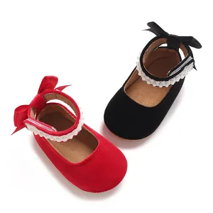 Pair of baby girl's velvet princess shoes in red and black with pearl straps and bows