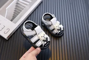 Macro detail of white baby boy closed-toe sandals featuring a cute 3D cartoon bear