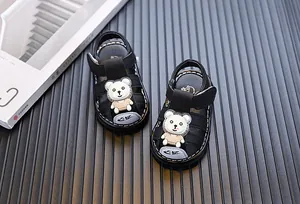 Close-up of black boys' closed-toe sandals with cute cartoon bear decoration