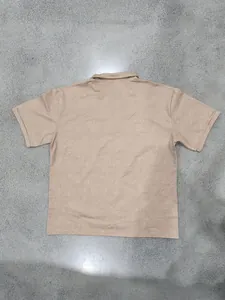 Back view of men's vintage distressed polo shirt on grey textured background
