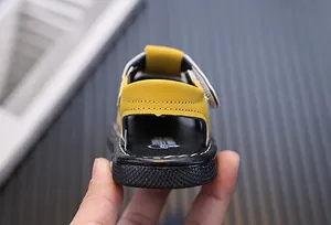 Rear view detail of yellow toddler boys closed-toe sandals with soft soles