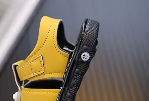 Detailed close-up view of toddler yellow sandal heel showing soft black rubber sole